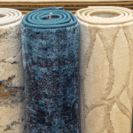 Several accent rugs rolled up and standing upright in a row