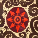 Rug featuring green and red Suzani pattern