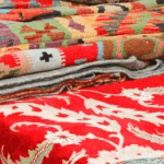 Pile of used Oriental rugs folded on a table