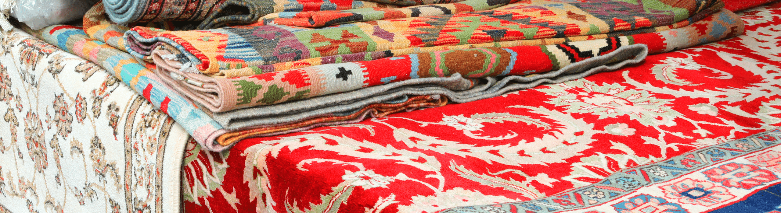 Pile of used Oriental rugs folded on a table