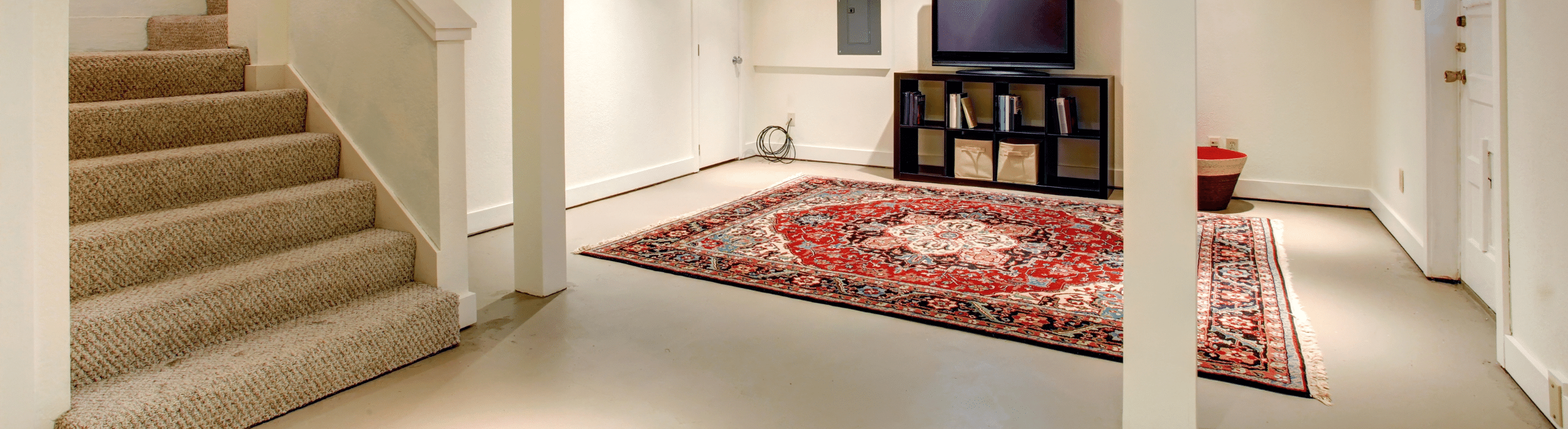 Finished basement with television and rug