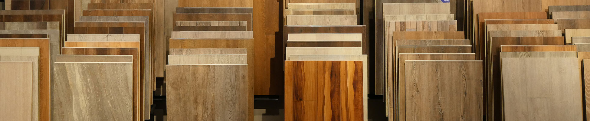 Planks of luxury vinyl tile that look like wood sitting upright in bins