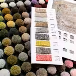 Colorful yarn samples and sample book showing custom rug options