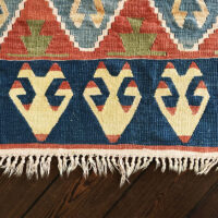 A rug with worn fringes in need of professional repair