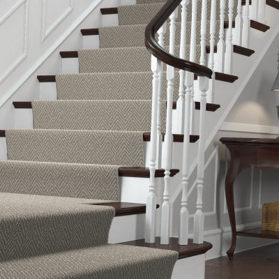 Gray stair runner installed on brown and white staircase in Cincinnati, Ohio