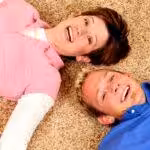 Man and woman laying on new carpet