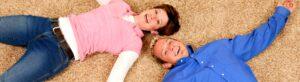 Man and woman laying on new carpet