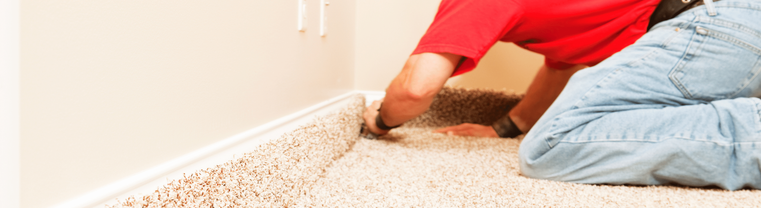 Professional carpet installation being done in home with beige carpet