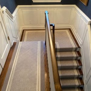 Gray and white stair runner on a installed on a wooden staircase in Cincinnati, Ohio