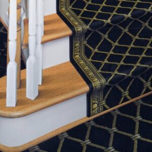 Black and gold custom stair runner installed on brown and white staircase in Cincinnati, Ohio