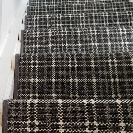 Stair runner with black, gray, and white plaid pattern