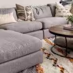 Area rug under gray couch