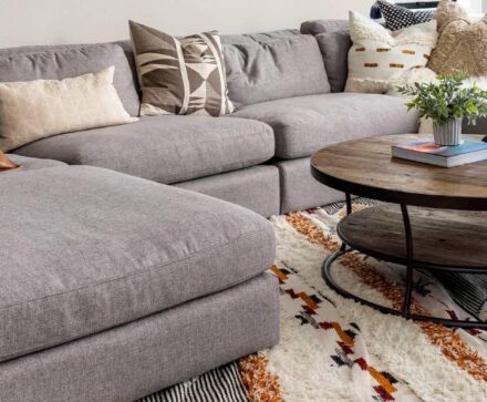 Area rug under gray couch