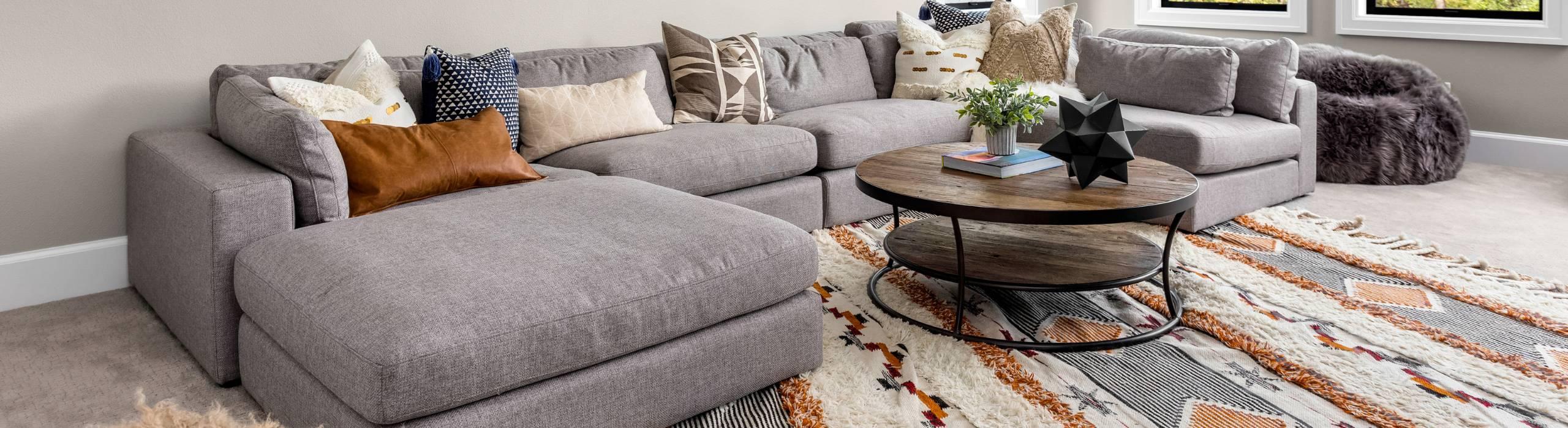 Area rug under gray couch