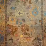 ruggallery-pantone-color-year-1 Closeup of traditional floral rug design featuring Pantone Color of the Year 2022, Very Peri, featuring shades of blue, gray, and red