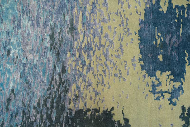 Closeup of modern rug design featuring Pantone Color of the Year 2022, Very Peri, along with shades of dark blue and gray