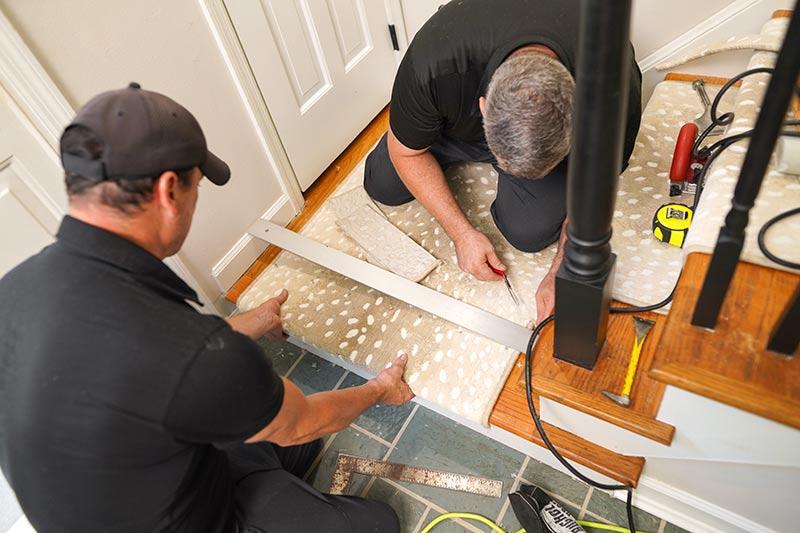 Two master carpet installers performing professional carpet installation in Cincinnati