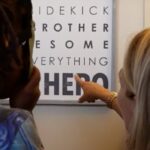 A women point to a sign with a kid