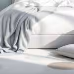 A bedroom that has two pillows on the rug